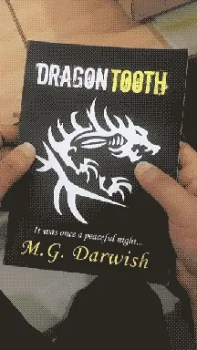 Cover of Dragon Tooth by M.G. Darwish, held in hand with a white dragon emblem
